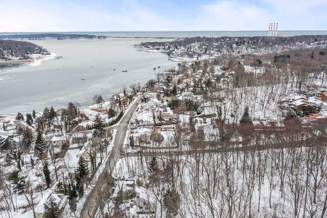 snowy aerial view featuring a water view