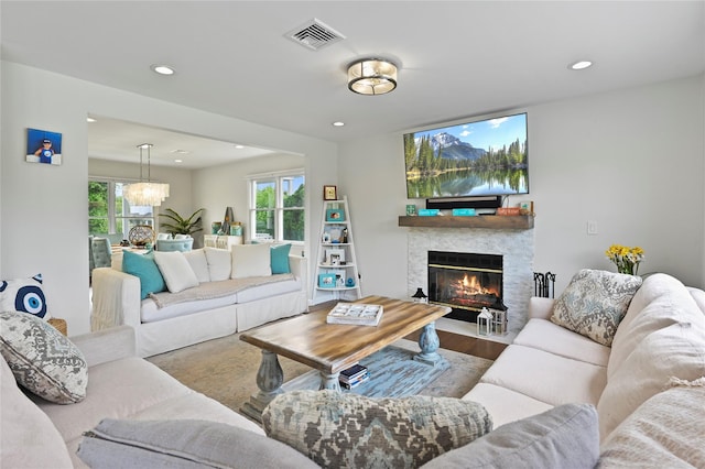 living room with hardwood / wood-style floors, a notable chandelier, and a healthy amount of sunlight