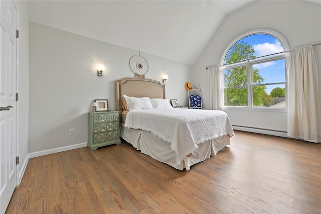 bedroom featuring lofted ceiling and hardwood / wood-style floors