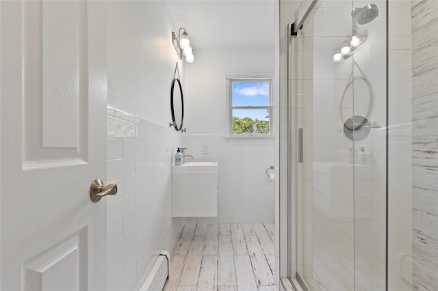 bathroom with tile walls, vanity, and walk in shower