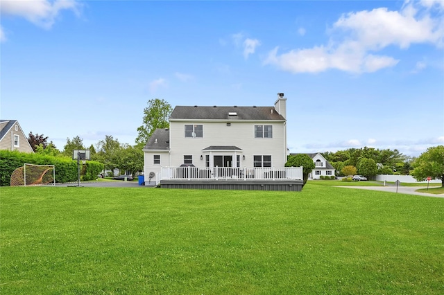 rear view of property featuring a lawn