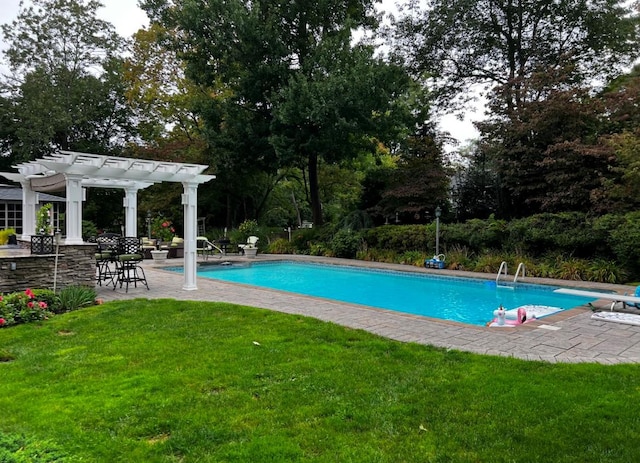 view of pool with a yard, a pergola, a diving board, and a patio