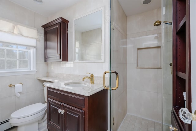 bathroom with walk in shower, toilet, tile walls, vanity, and a baseboard heating unit