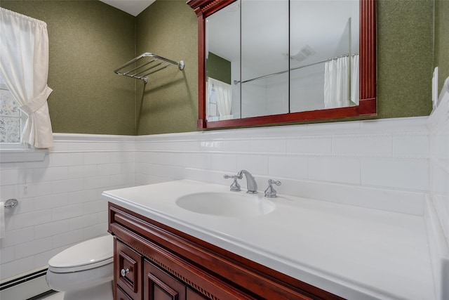 bathroom with vanity, tile walls, baseboard heating, and toilet