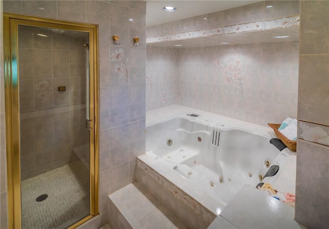 bathroom featuring separate shower and tub