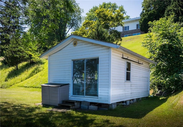 view of side of home with a yard