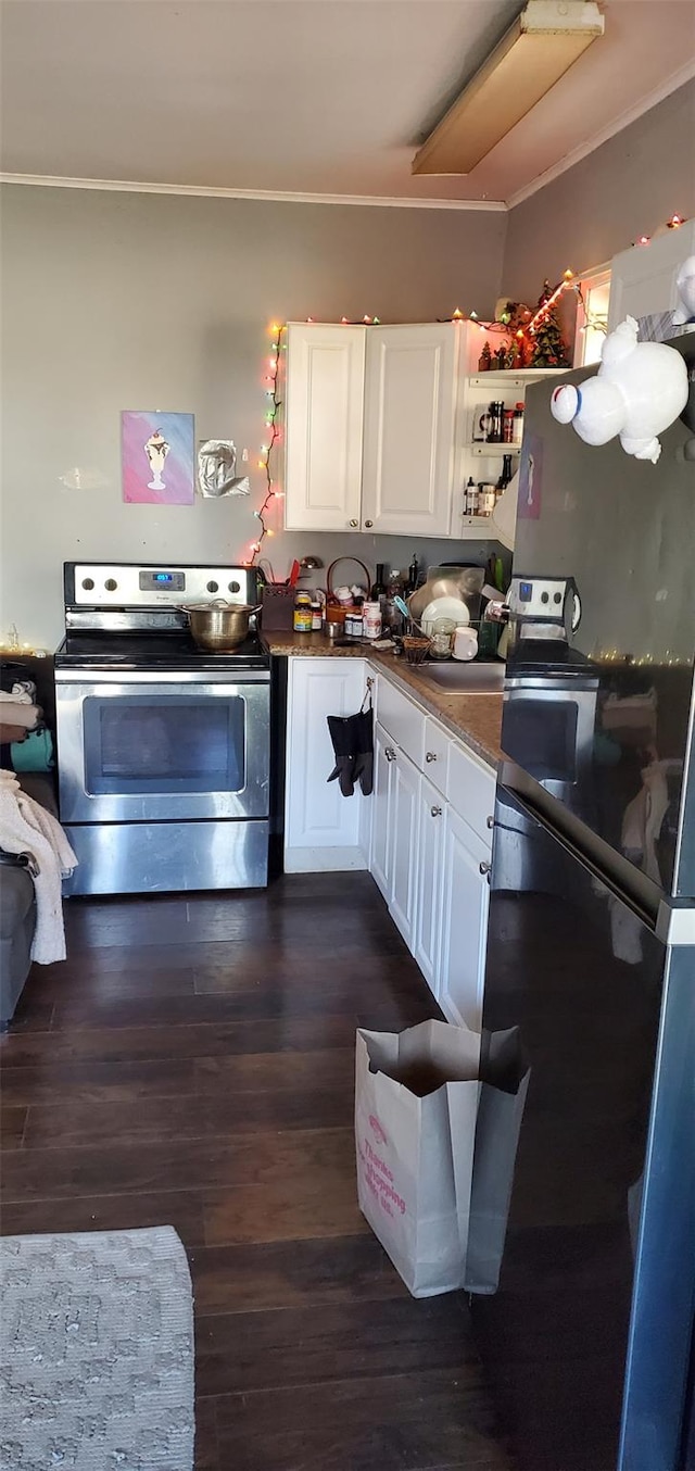 kitchen featuring crown molding, black refrigerator, dark hardwood / wood-style flooring, white cabinetry, and electric stove