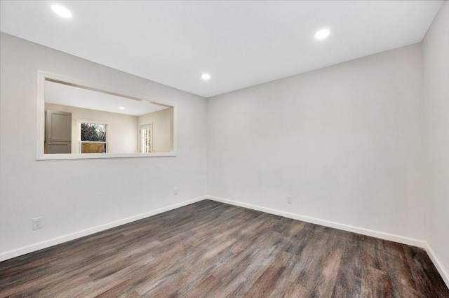 empty room with dark hardwood / wood-style floors