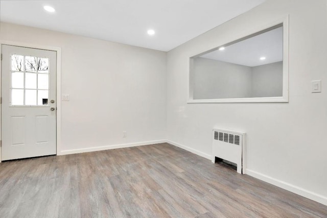 entryway featuring radiator heating unit and light hardwood / wood-style flooring