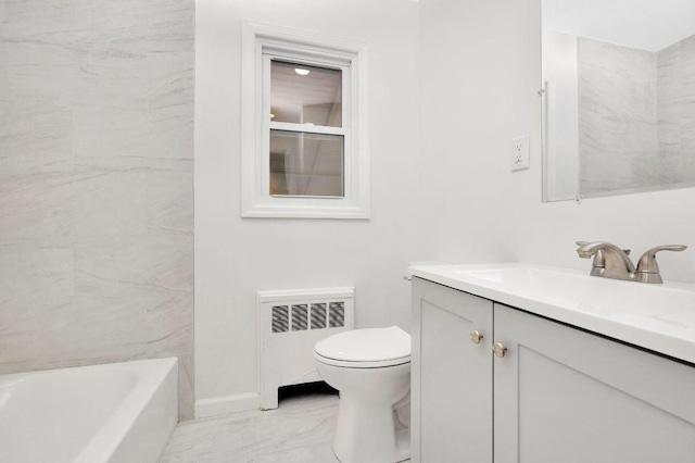 bathroom featuring a washtub, toilet, radiator heating unit, and vanity