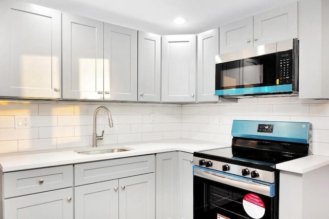 kitchen featuring decorative backsplash, sink, and stainless steel appliances