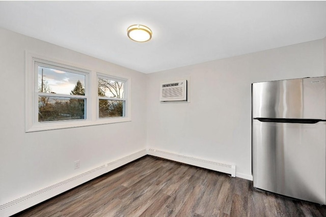 empty room with a wall unit AC and dark hardwood / wood-style floors