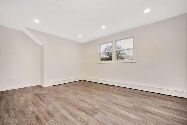 spare room with light hardwood / wood-style floors and a baseboard radiator