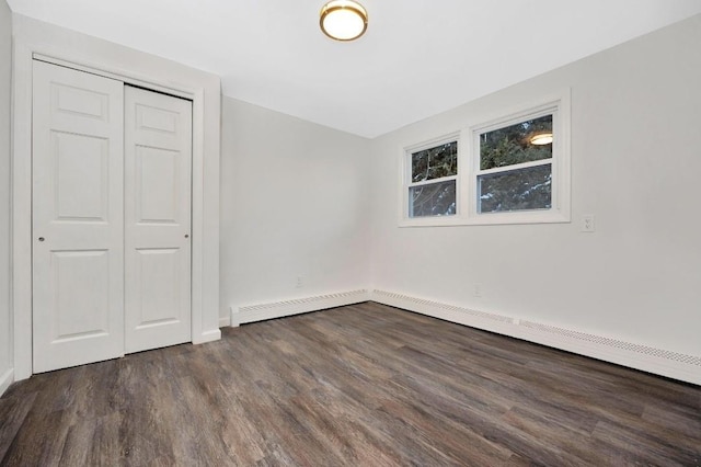 unfurnished bedroom featuring a closet and dark wood-type flooring