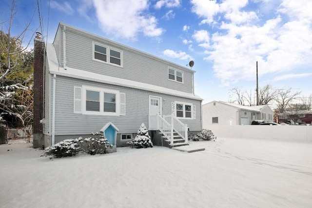 view of snow covered rear of property