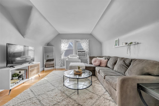 living room with vaulted ceiling and light wood-type flooring