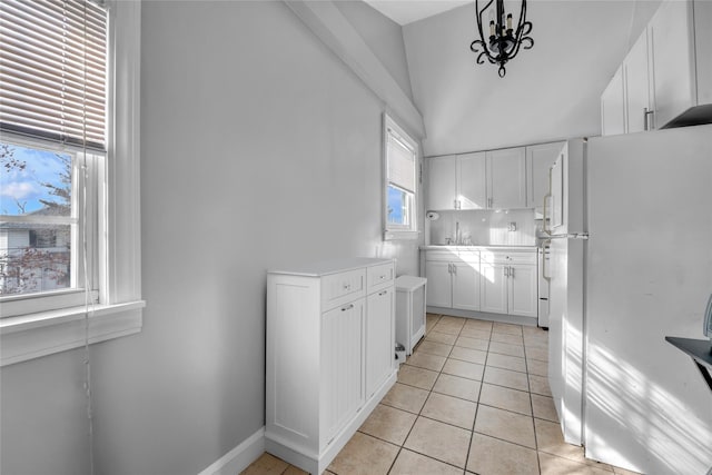 kitchen with white cabinetry, a healthy amount of sunlight, white fridge, and pendant lighting