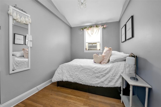 bedroom featuring lofted ceiling and hardwood / wood-style flooring