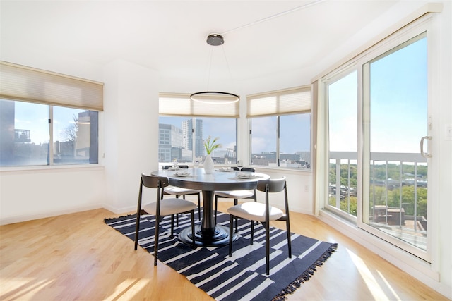 dining area featuring plenty of natural light and light hardwood / wood-style floors