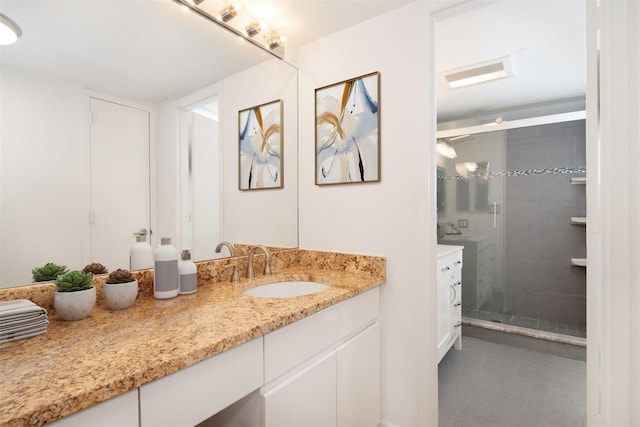 bathroom with vanity, tile patterned flooring, and a shower with door