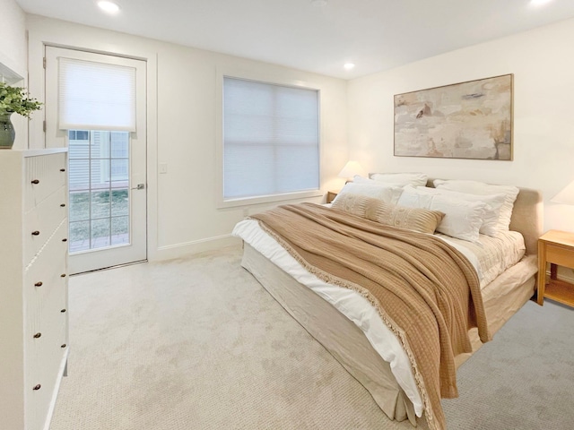 bedroom with light colored carpet and access to outside