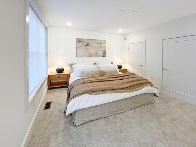 bedroom with light colored carpet