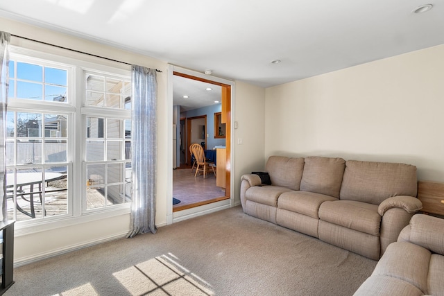 carpeted living room featuring plenty of natural light