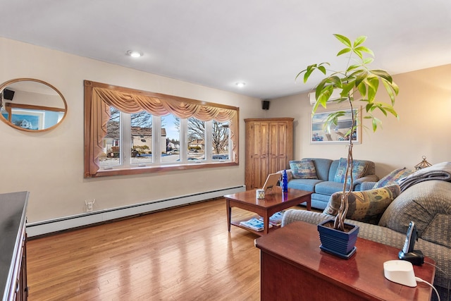 living room with light hardwood / wood-style floors and baseboard heating