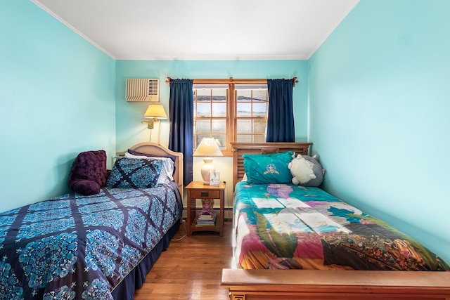 bedroom featuring hardwood / wood-style flooring and ornamental molding