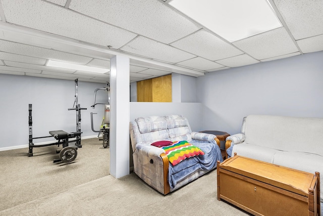 carpeted bedroom featuring a drop ceiling