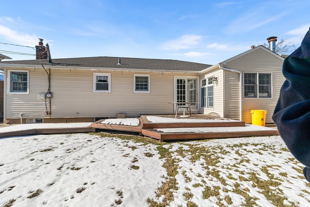 snow covered property with a wooden deck