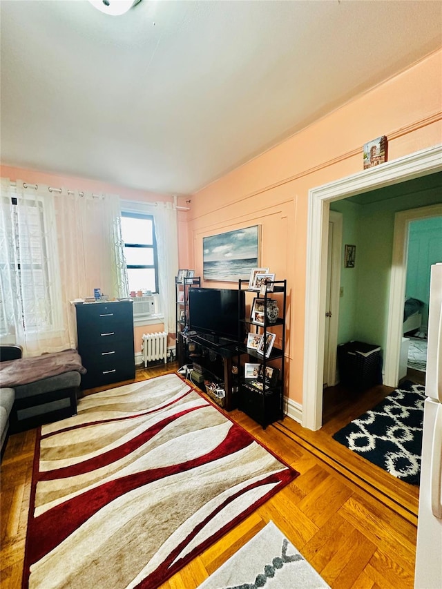 living room featuring cooling unit, parquet flooring, and radiator heating unit