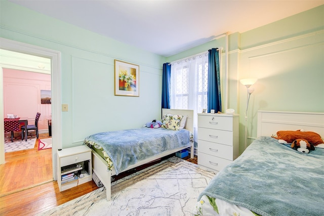 bedroom with hardwood / wood-style flooring