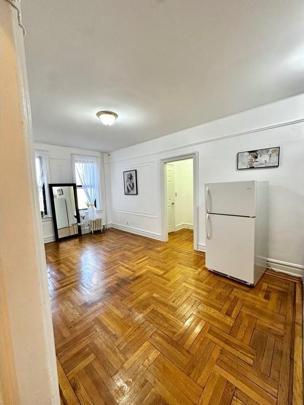 interior space with baseboards and radiator