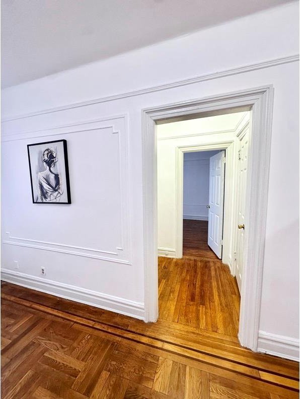 hallway featuring baseboards