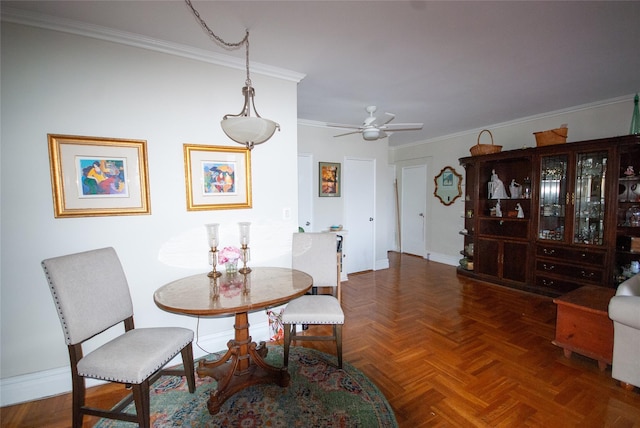 dining room with ceiling fan, baseboards, and ornamental molding