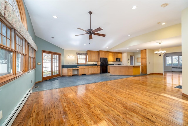 kitchen featuring radiator heating unit, black appliances, a baseboard heating unit, kitchen peninsula, and light wood-type flooring