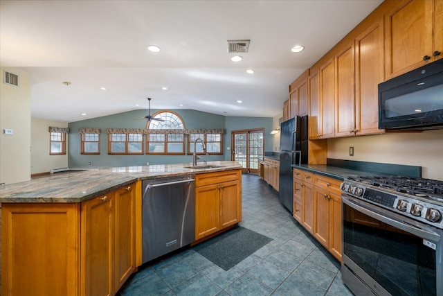 kitchen featuring black appliances, lofted ceiling, ceiling fan, sink, and light stone counters