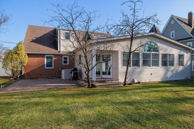 rear view of property featuring a patio area and a yard