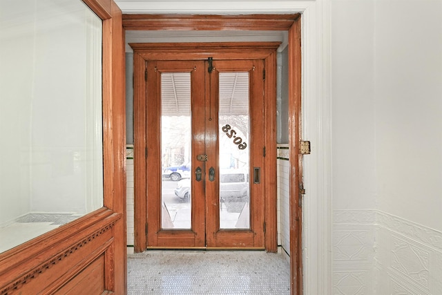 entryway with french doors and light tile patterned floors