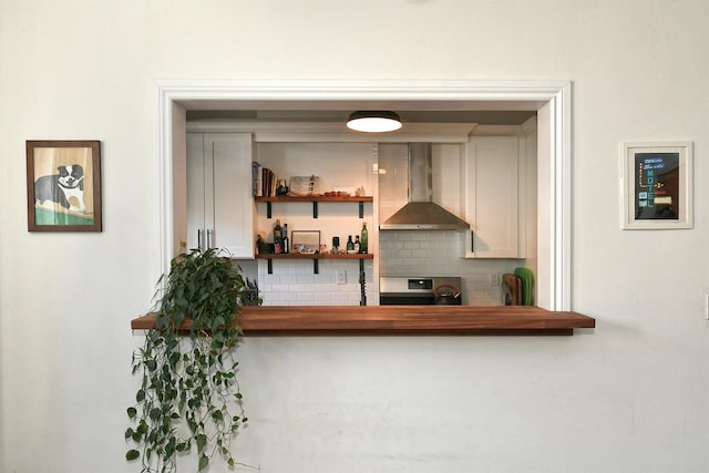 bar with electric stove, wall chimney range hood, and tasteful backsplash