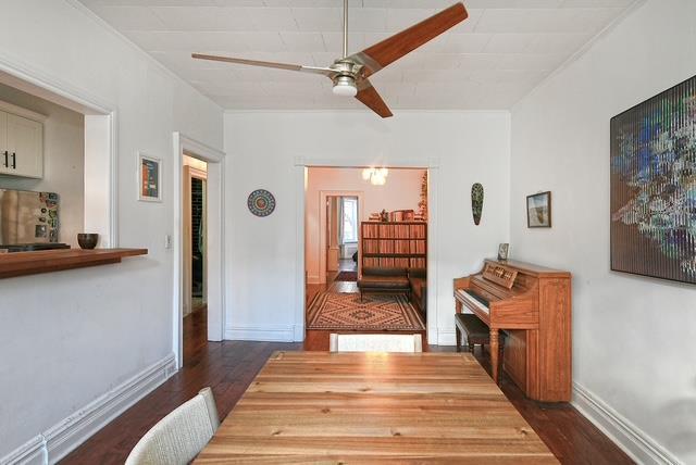 interior space with ceiling fan and dark hardwood / wood-style flooring