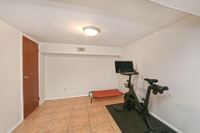 exercise room with light tile patterned floors