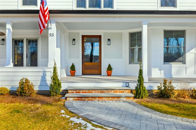 view of exterior entry with a porch