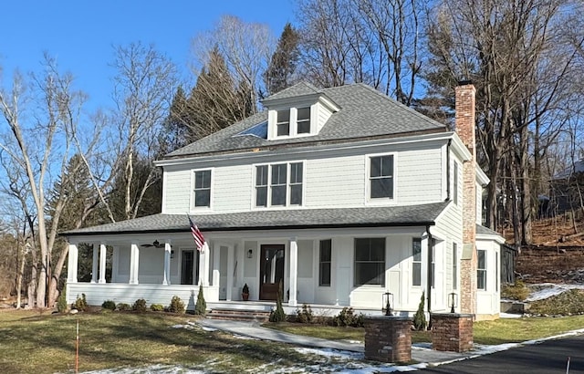 farmhouse-style home with a porch and a front lawn