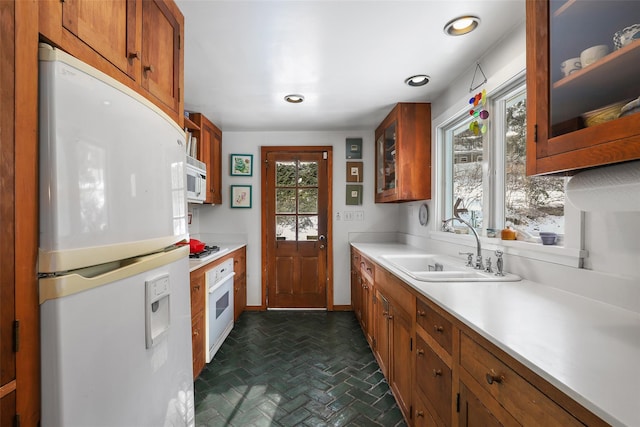 kitchen featuring sink and white appliances