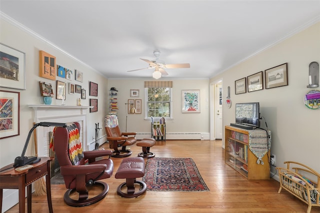 sitting room featuring ornamental molding, light hardwood / wood-style floors, and ceiling fan