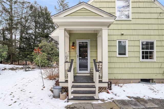 view of snow covered property entrance