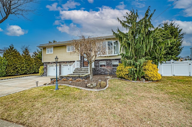 raised ranch with a garage and a front lawn