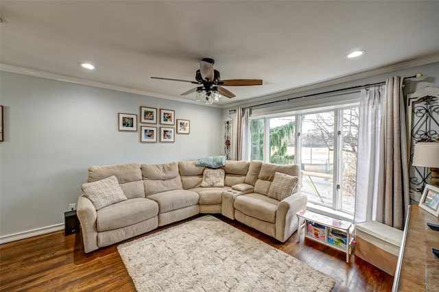 living room featuring ceiling fan, dark hardwood / wood-style floors, and crown molding